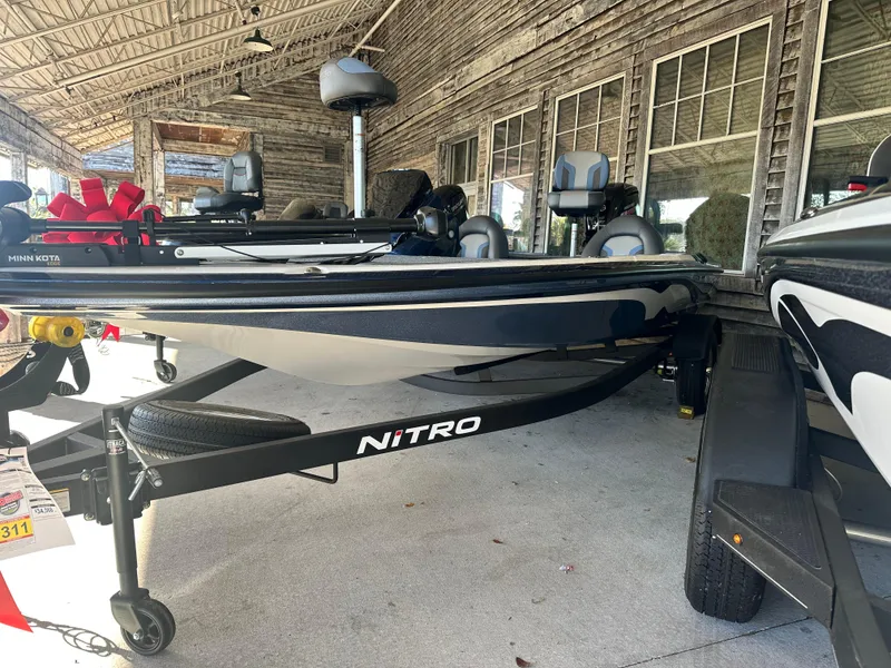 Slide: The Image of 2025 Nitro Z17 boat on trailer, parked under rustic wooden shelter. - 1