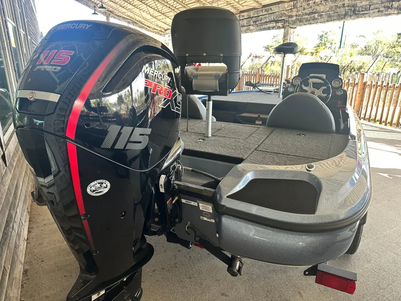 Slide: The Image of Nitro Z17 2025 boat with Mercury 115 Pro motor, parked under a canopy. - 3