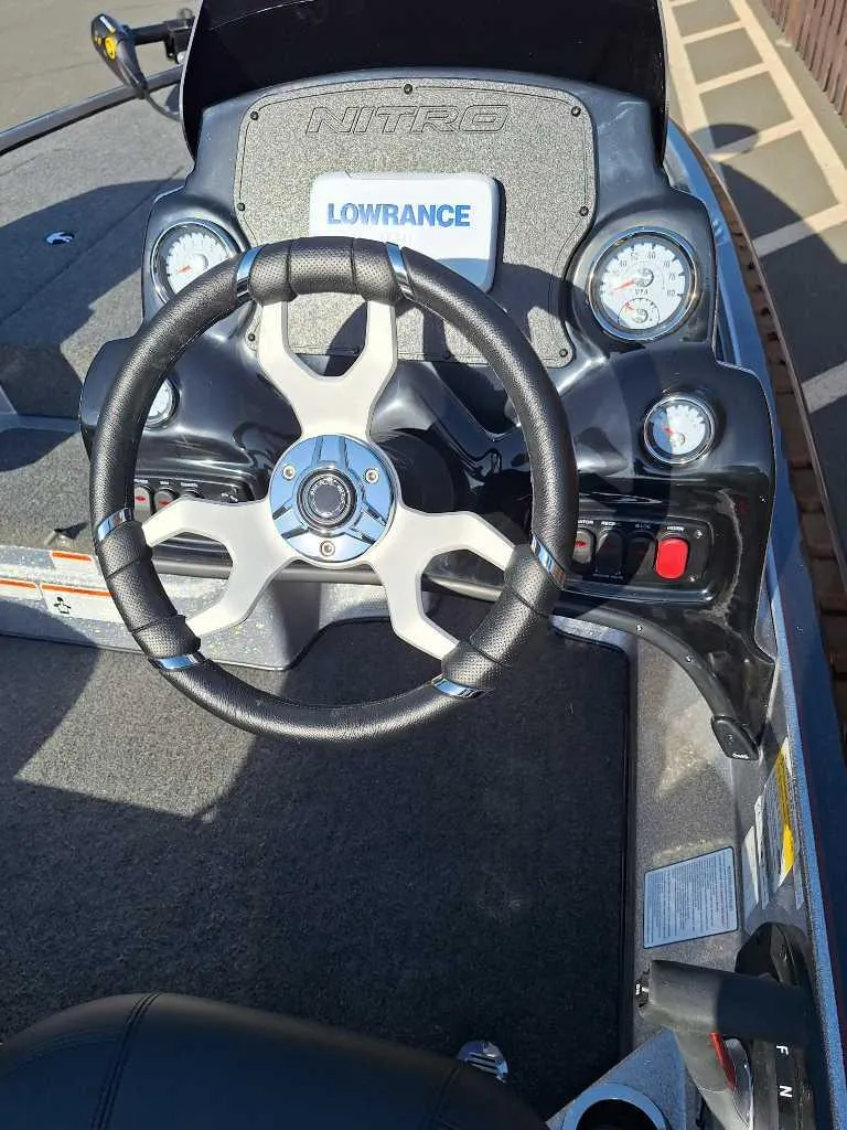 Slide: The Image of 2025 Nitro Z17 boat dashboard with steering wheel and Lowrance display. - 3