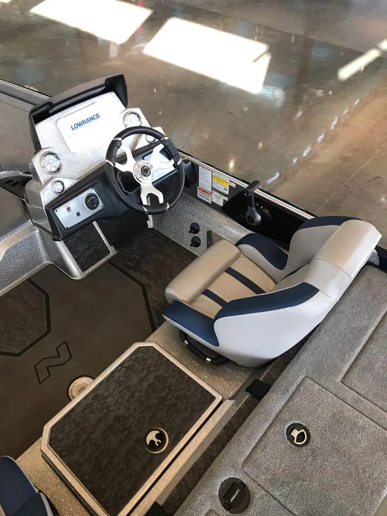 Slide: The Image of 2025 Nitro Z21 XL boat interior with steering wheel and seating. - 2