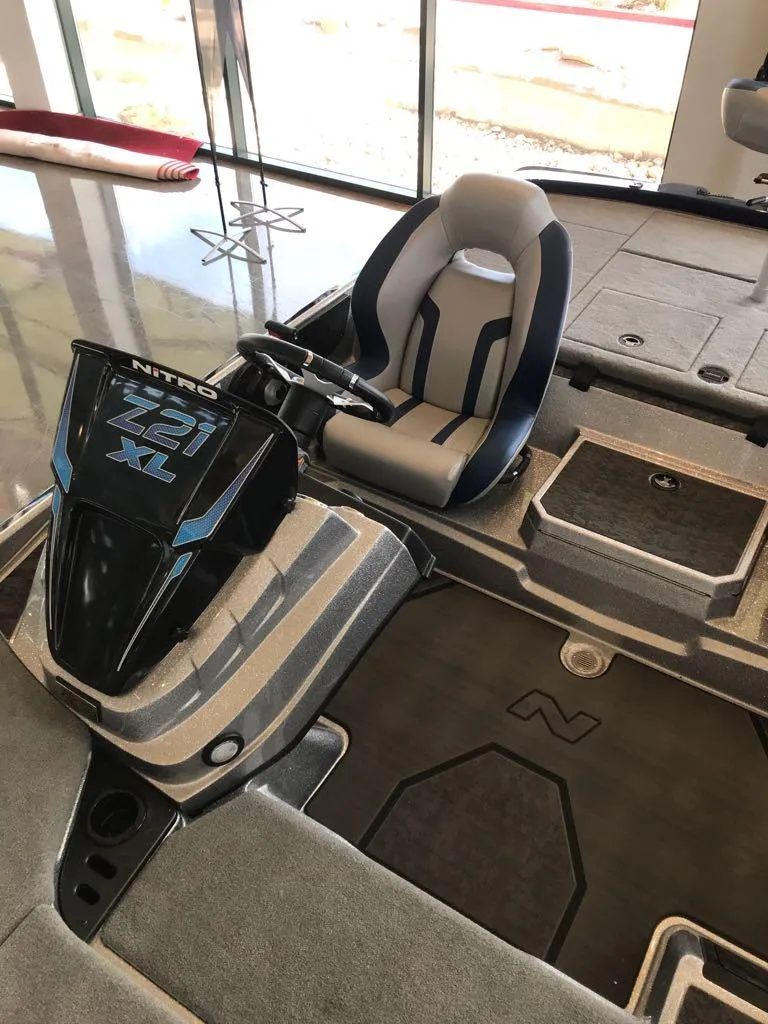 Slide: The Image of 2025 Nitro Z21 XL boat interior with steering console and seating. - 4
