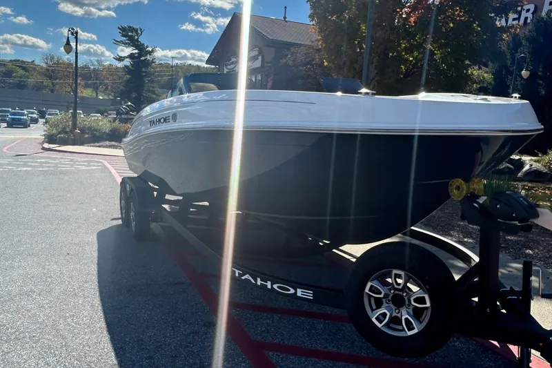 Slide: The Image of 2025 Tahoe T21 boat on trailer in sunny outdoor setting. - 2
