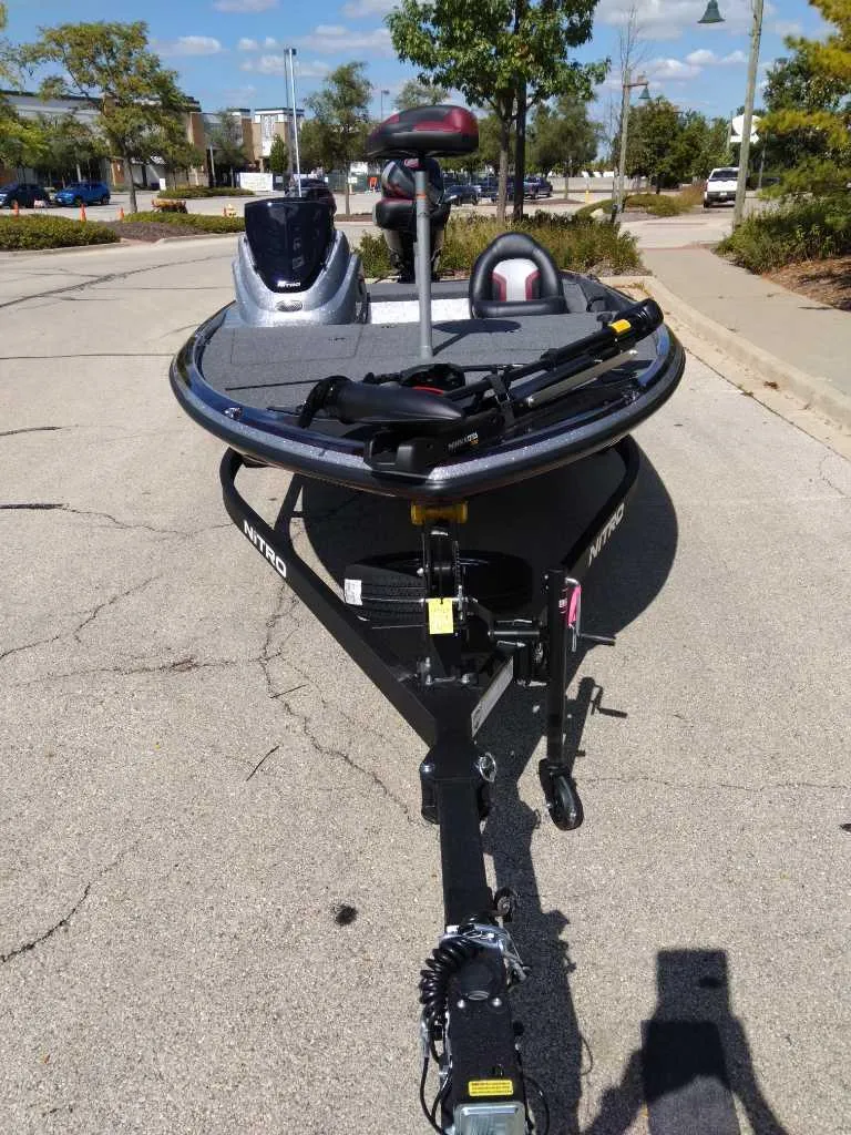 Slide: The Image of 2025 Nitro Z17 boat on trailer, parked on a sunny street. - 3