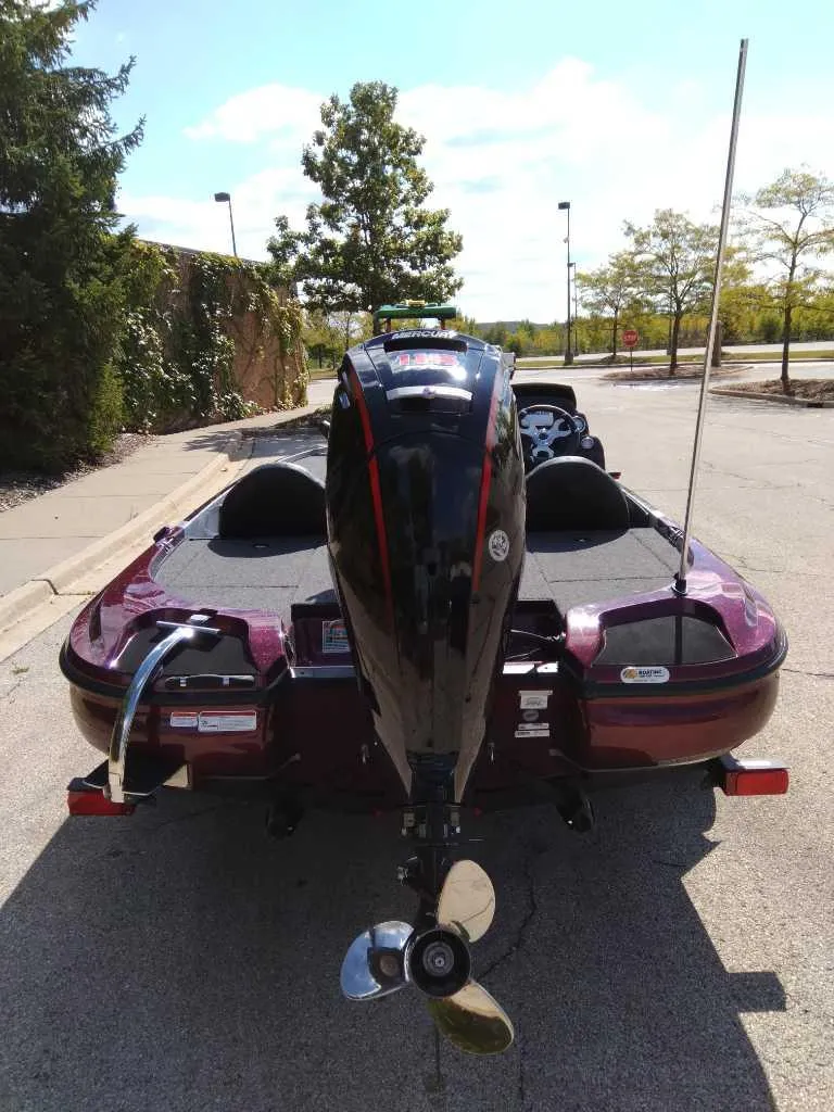 Slide: The Image of 2025 Nitro Z17 boat with outboard motor, parked on a sunny street. - 4