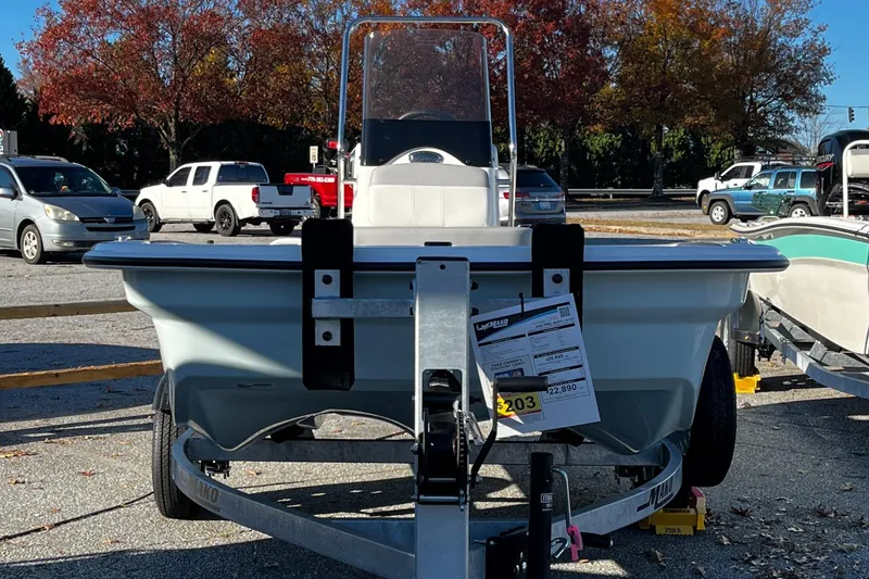 Slide: The Image of 2025 Mako Pro Skiff 13 CC boat on trailer in parking lot. - 1