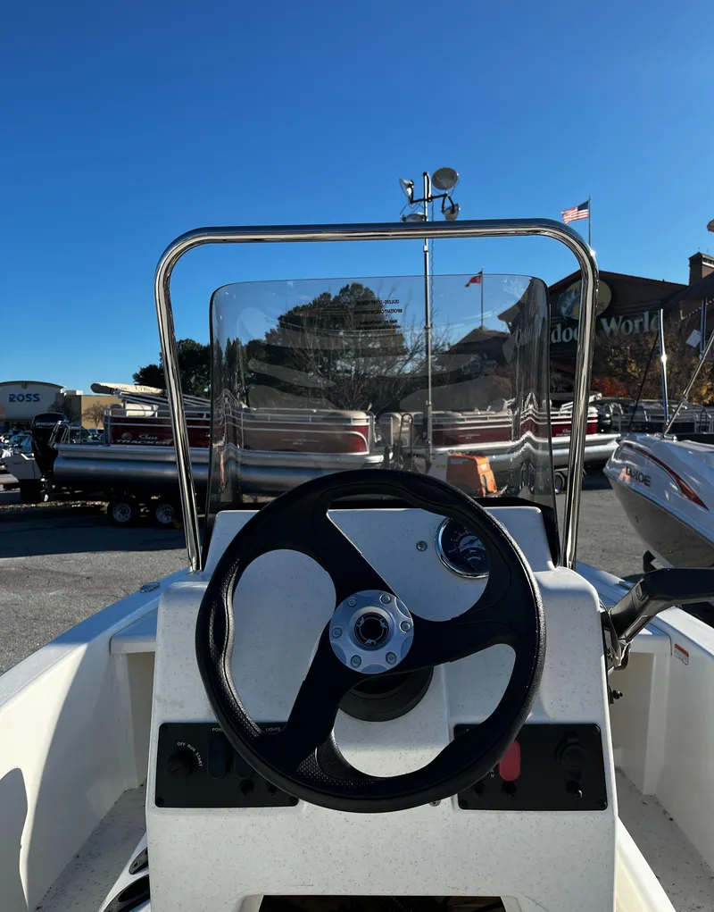Slide: The Image of 2025 Mako Pro Skiff 13 CC boat steering console with clear windshield. - 2