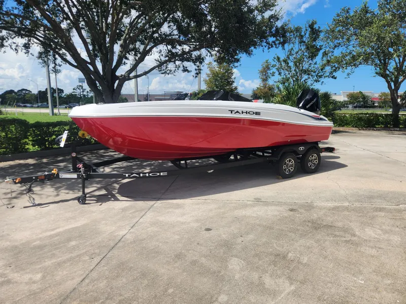 The Image of 2025 Tahoe T21 boat on trailer, red and white design, parked outdoors. - 0