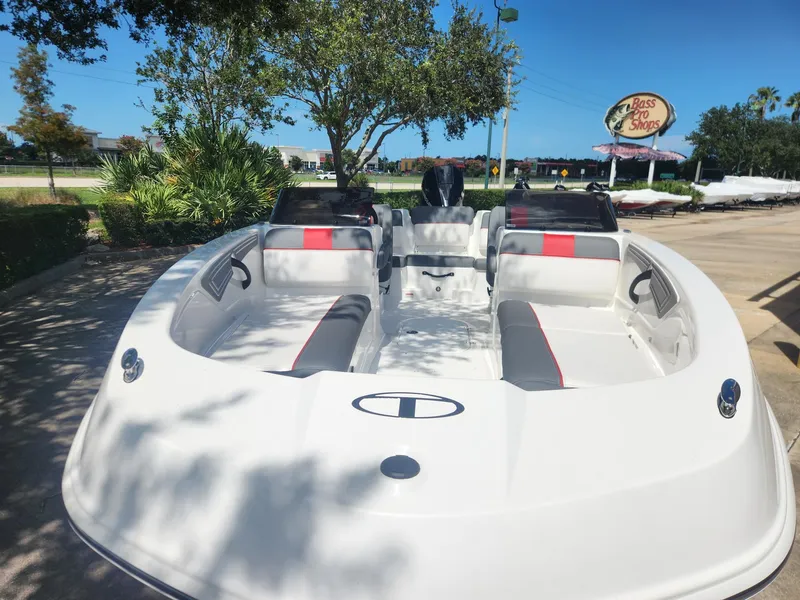 Slide: The Image of 2025 Tahoe T21 boat with sleek design, parked outdoors under clear blue sky. - 3