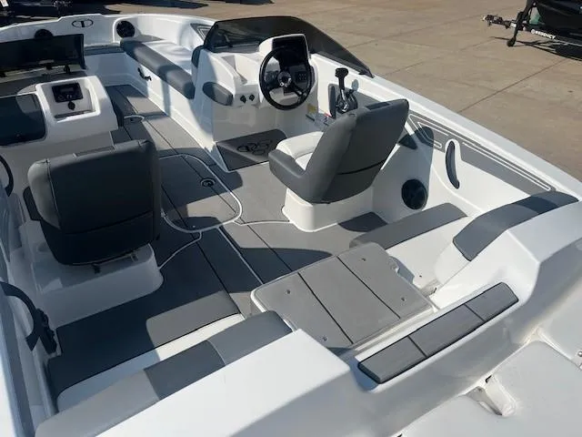 Slide: The Image of 2025 Tahoe T21 boat interior with modern seating and steering console. - 2