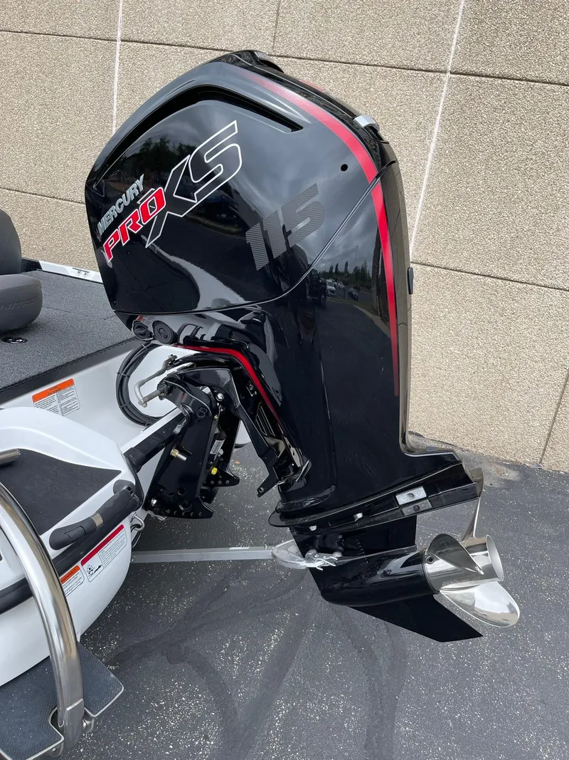 Slide: The Image of Nitro Z17 2025 boat with Mercury Pro XS outboard motor, sleek black and red design. - 2