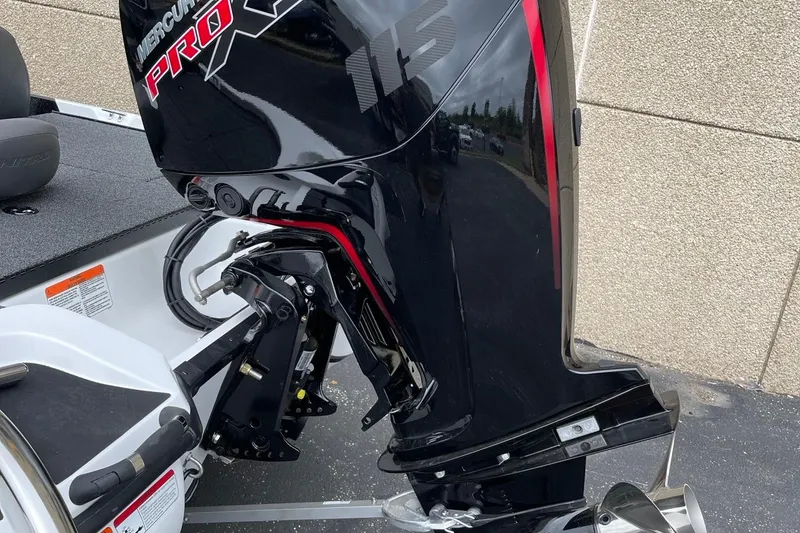 Slide: The Image of 2025 Nitro Z17 boat with Mercury Pro XS outboard motor, parked on pavement. - 64