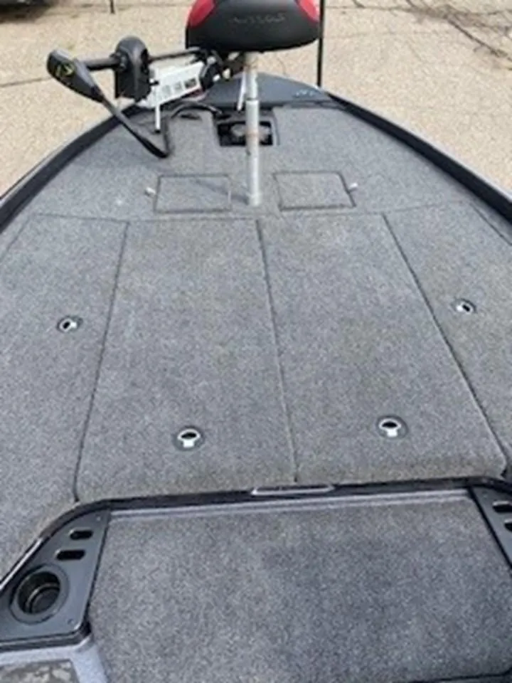 Slide: The Image of 2025 Nitro Z21 XL boat deck with gray carpeting and fishing seat. - 10