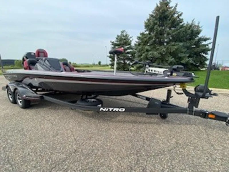 Slide: The Image of 2025 Nitro Z21 XL bass boat on trailer, parked outdoors. - 12