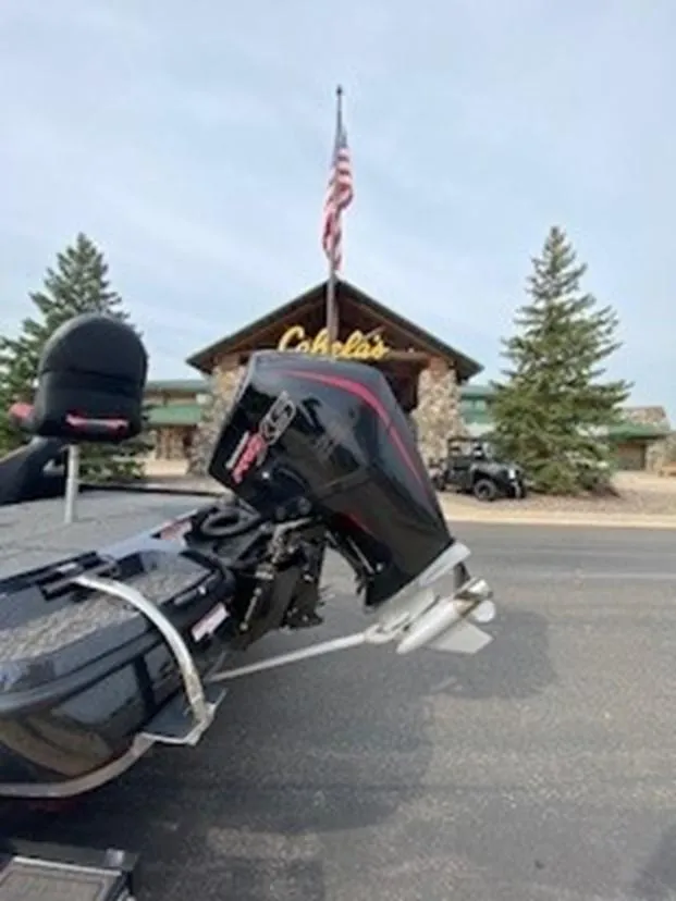 Slide: The Image of 2025 Nitro Z21 XL boat outside Cabela's store with American flag. - 2