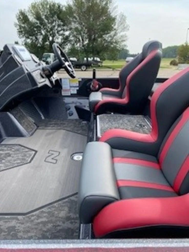 Slide: The Image of 2025 Nitro Z21 XL boat interior with red and gray seats. - 8