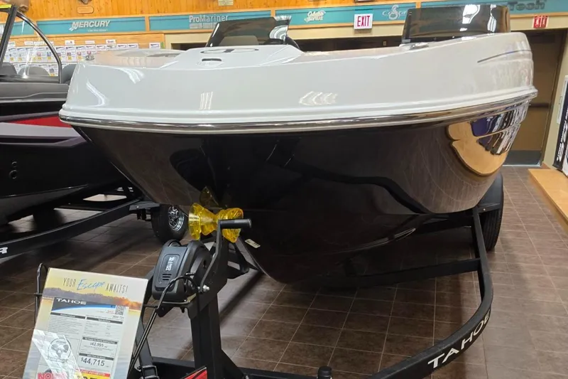 Slide: The Image of 2025 Tahoe T21 boat displayed indoors on a trailer. - 0