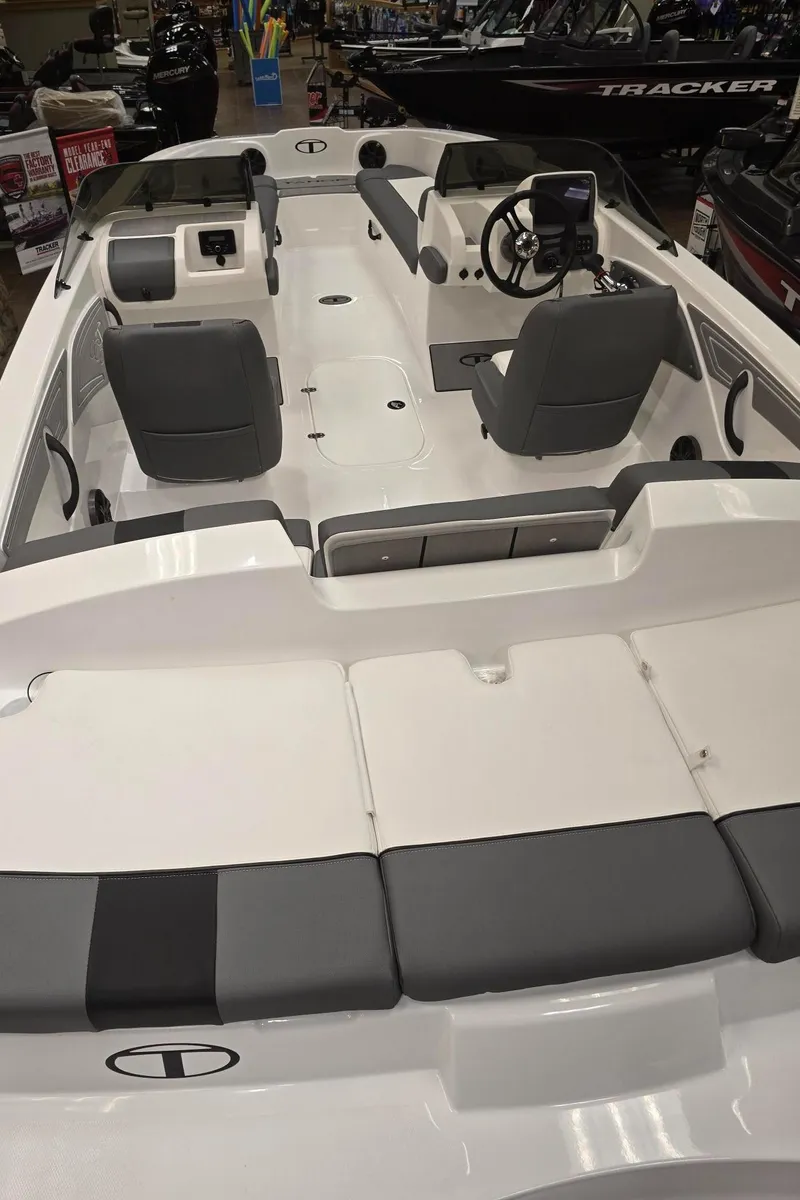 Slide: The Image of 2025 Tahoe T21 boat interior with gray seating and modern dashboard. - 3