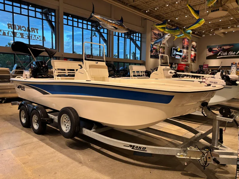 Slide: The Image of 2025 Mako Pro Skiff 19 CC boat displayed in showroom on trailer. - 0