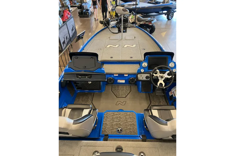 Slide: The Image of 2025 Nitro Z21 XL Pro boat interior with steering wheel and seating. - 7