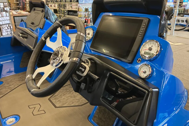 Slide: The Image of 2025 Nitro Z21 XL Pro boat dashboard with steering wheel and digital display. - 4