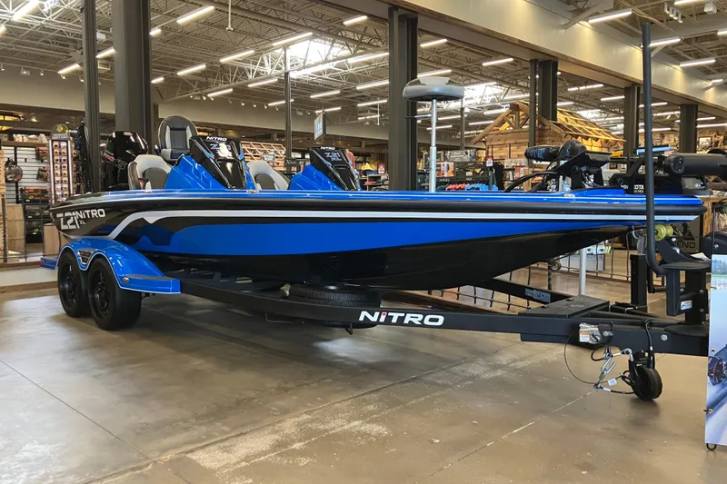 The Image of 2025 Nitro Z21 XL Pro boat in showroom, featuring sleek blue design and modern amenities. - 0