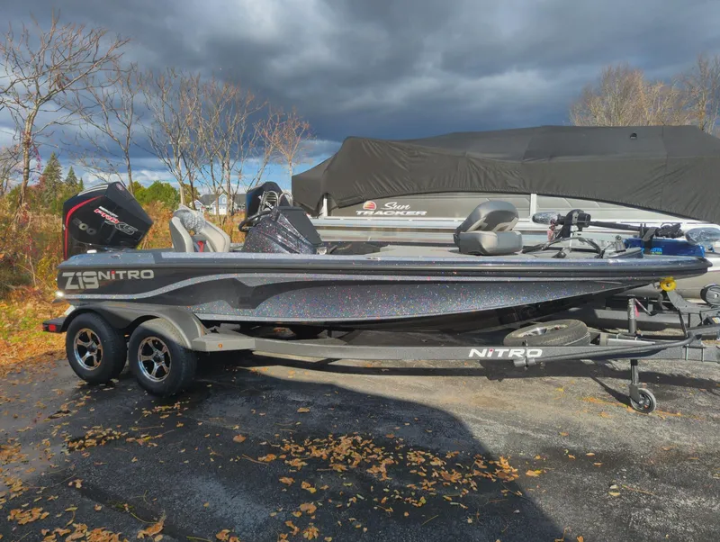 Slide: The Image of 2025 Nitro Z19 Pro boat on trailer, parked outdoors under cloudy sky. - 1