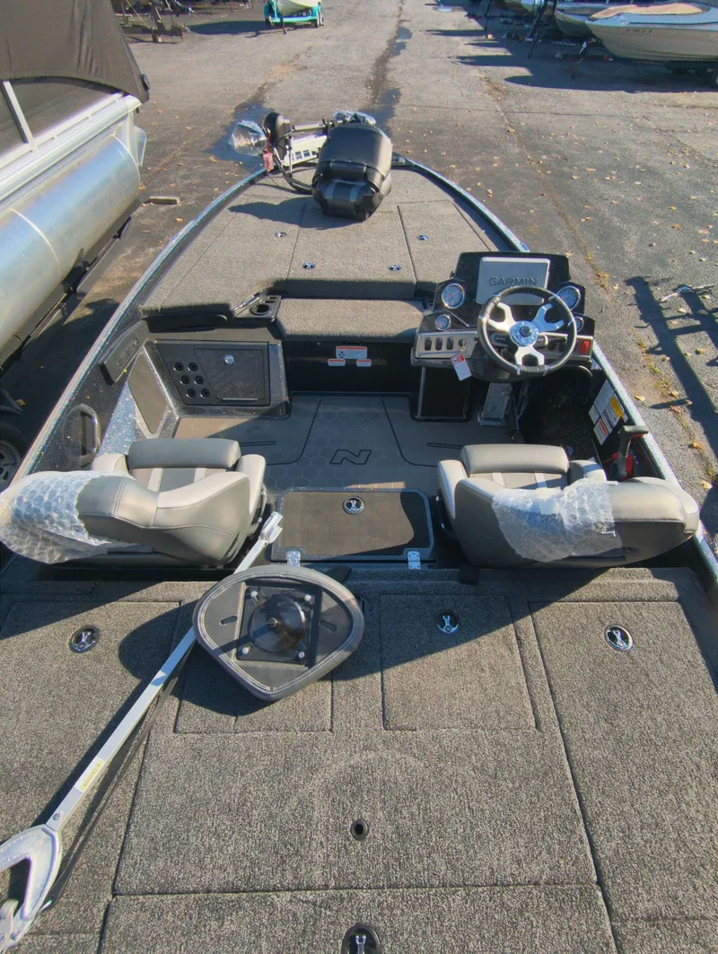 Slide: The Image of 2025 Nitro Z19 Pro fishing boat interior with steering console and seating. - 11