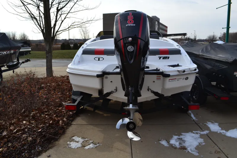 Slide: The Image of 2025 Tahoe T21 boat with powerful outboard motor, parked on a concrete surface. - 1