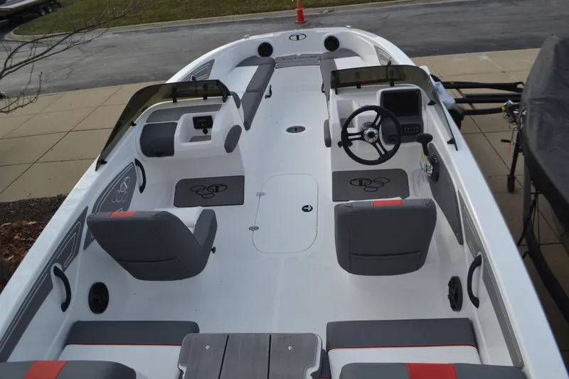 Slide: The Image of 2025 Tahoe T21 boat interior with gray seating and modern dashboard. - 2