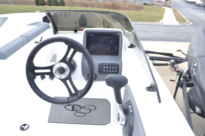 Slide: The Image of 2025 Tahoe T21 boat dashboard with steering wheel and control panel. - 3