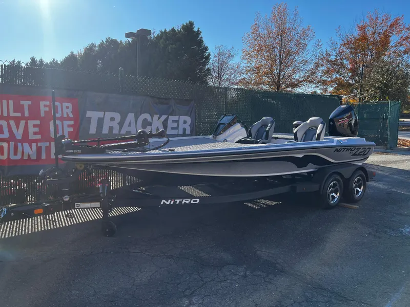 Slide: The Image of 2025 Nitro Z20 XL boat on trailer, parked outdoors with autumn trees in background. - 1