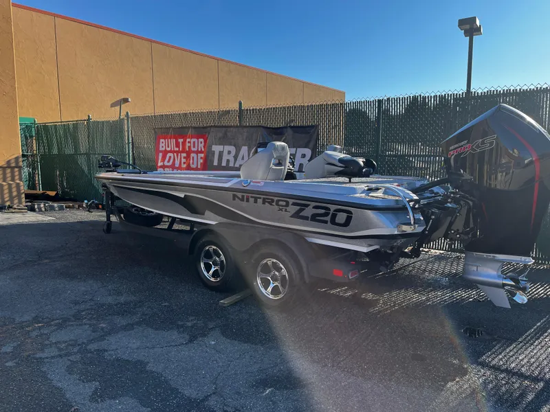 Slide: The Image of 2025 Nitro Z20 XL boat on trailer in outdoor setting. - 2