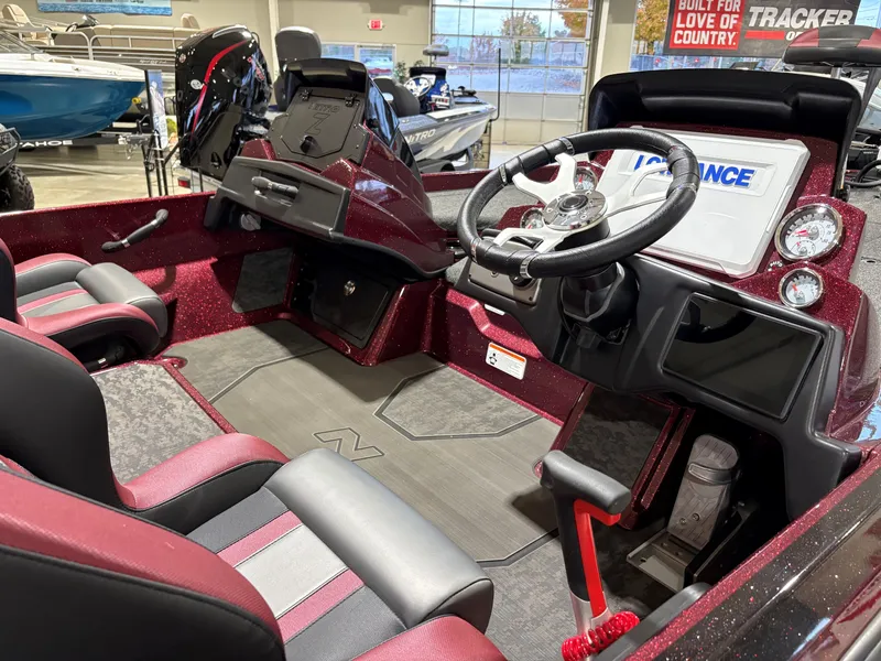 Slide: The Image of 2025 Nitro Z21 XL boat interior with steering wheel and seating in showroom. - 4
