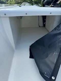 Slide: The Image of 2025 Mako Pro Skiff 17 CC storage compartment with black cover. - 46