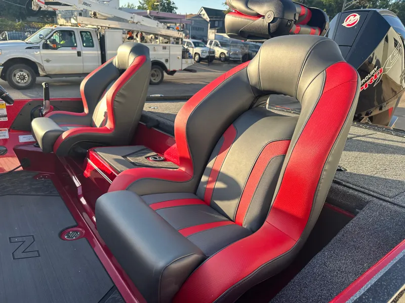 Slide: The Image of 2025 Nitro Z20 XL Pro boat seats, red and black design, parked outdoors. - 10