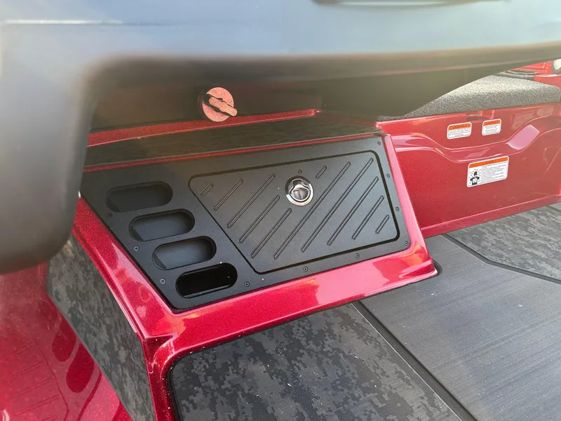 Slide: The Image of 2025 Nitro Z20 XL Pro boat interior storage compartment, red and black design. - 11
