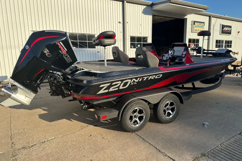 Slide: The Image of 2025 Nitro Z20 XL Pro boat with powerful engine, parked outside a warehouse. - 2