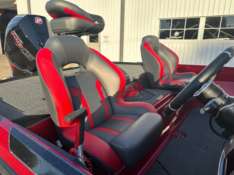 Slide: The Image of 2025 Nitro Z20 XL Pro boat interior with red and black seats, steering wheel, and motor. - 7