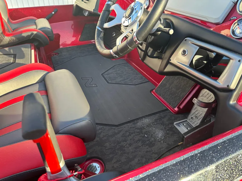 Slide: The Image of Interior of 2025 Nitro Z20 XL Pro boat with red and black seating and steering wheel. - 9