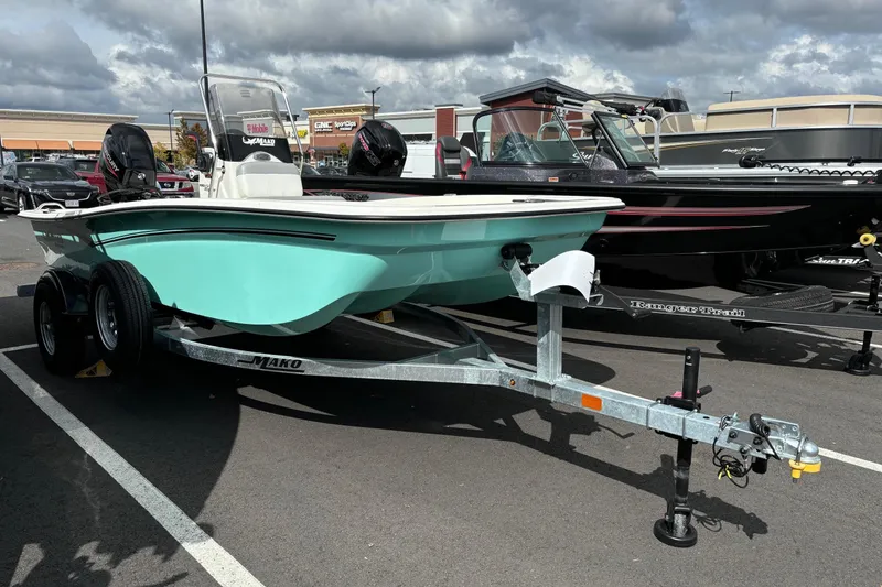 Slide: The Image of 2025 Mako Pro Skiff 15 CC boat on trailer in parking lot. - 1