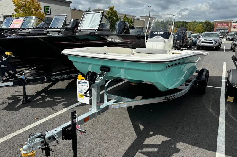 Slide: The Image of 2025 Mako Pro Skiff 15 CC boat on trailer in parking lot. - 2