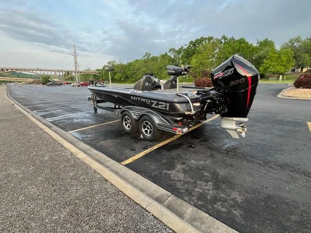 Slide: The Image of 2025 Nitro Z21 XL boat on trailer, parked near a scenic waterfront. - 4