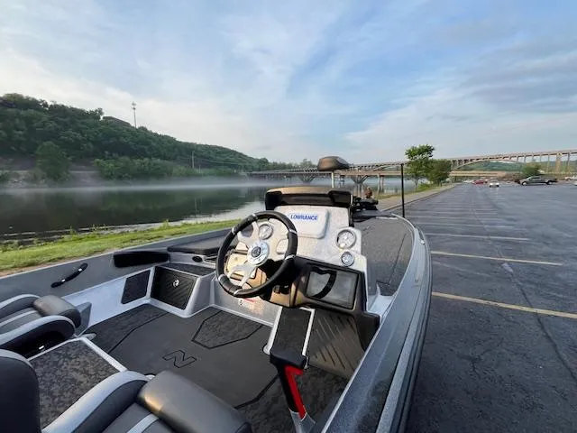 Slide: The Image of 2025 Nitro Z21 XL boat with powerful outboard motor in a parking lot. - 5