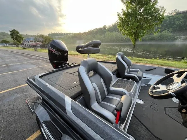 Slide: The Image of 2025 Nitro Z21 XL boat with powerful outboard motor, parked in a lot. - 6