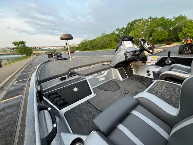 Slide: The Image of 2025 Nitro Z21 XL boat with powerful outboard motor, parked near a scenic river. - 7