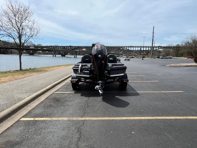 Slide: The Image of 2025 Nitro Z20 XL boat parked near a river with a bridge in the background. - 6