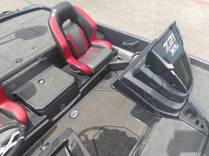 Slide: The Image of 2025 Nitro Z21 XL boat interior with red and black seats and dashboard. - 10