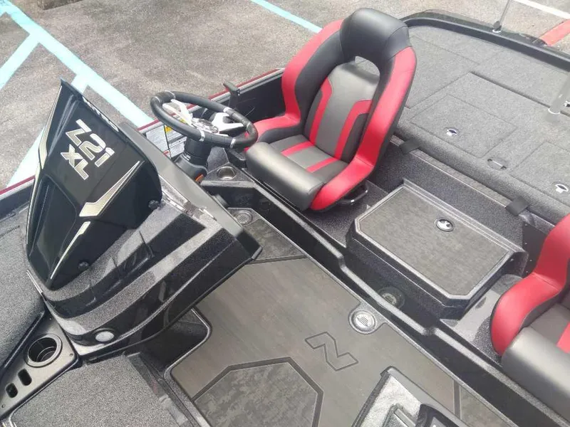 Slide: The Image of 2025 Nitro Z21 XL boat interior with red and black seating and steering console. - 11