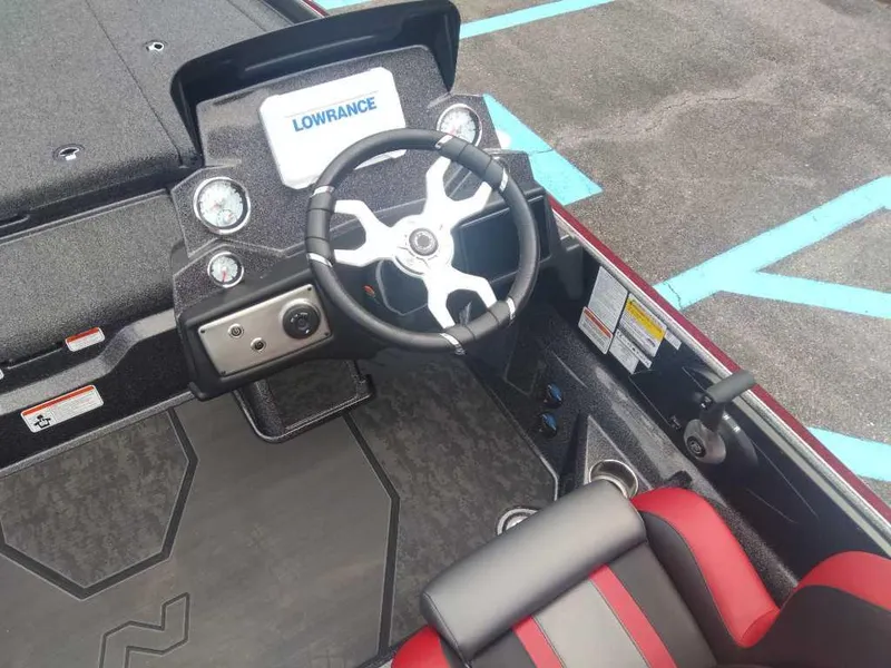 Slide: The Image of 2025 Nitro Z21 XL boat cockpit with steering wheel and Lowrance display. - 14