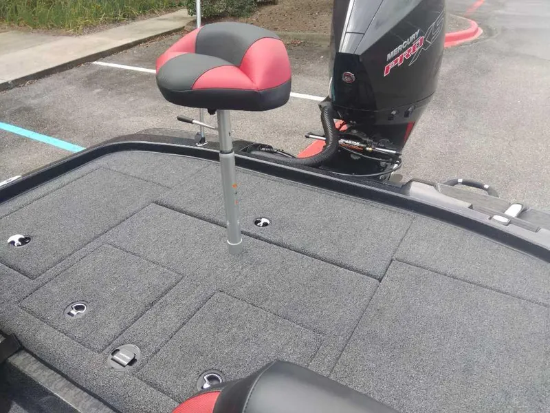 Slide: The Image of 2025 Nitro Z21 XL boat deck with red and black seat, featuring storage compartments. - 15